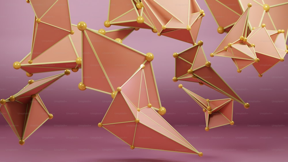 um grupo de objetos geométricos rosa e dourado