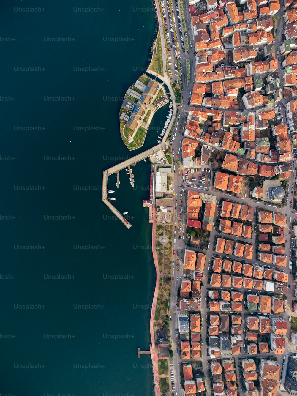 a bird's eye view of a city next to a body of water