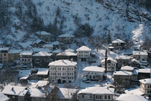 a snow covered town with a mountain in the background