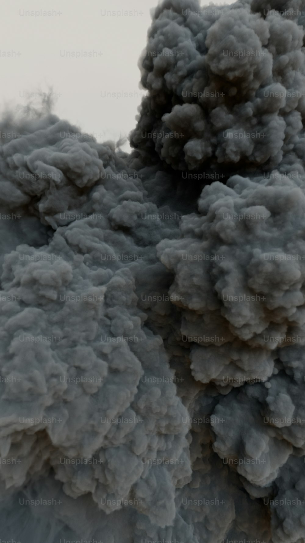 smoke is billowing out of the top of a building