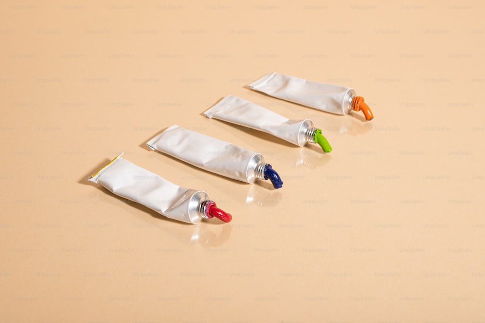 a group of three small toothbrushes sitting on top of a table