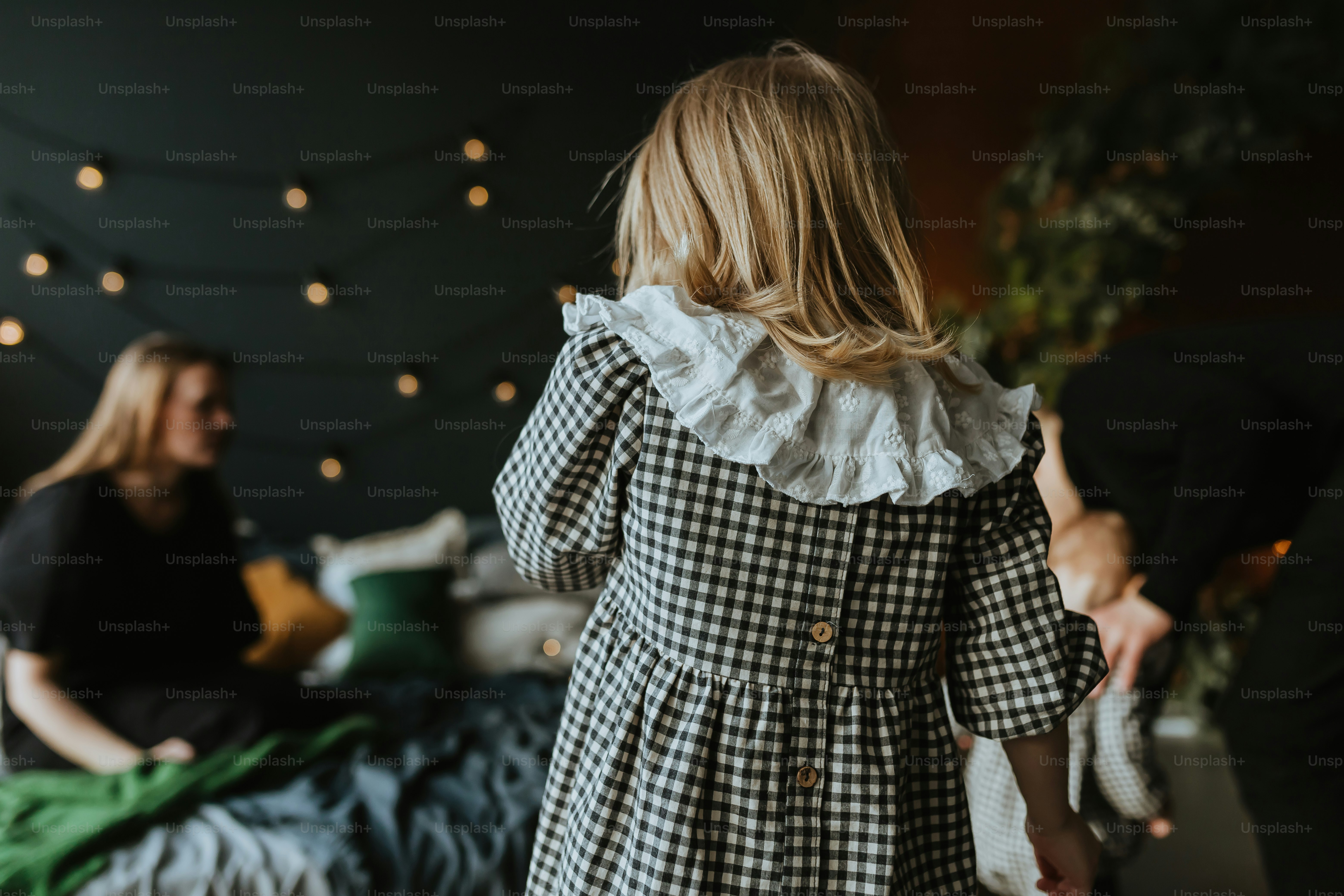 a little girl in a black and white checkered dress