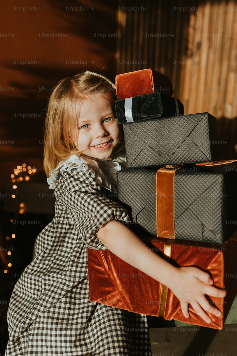 una bambina che tiene una pila di bagagli