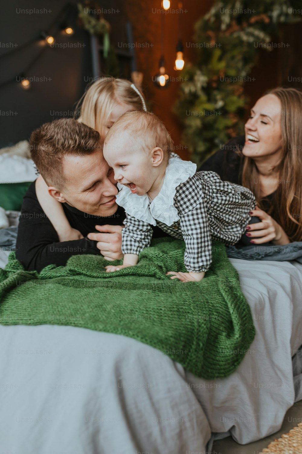 a man and a woman laying on a bed with a baby