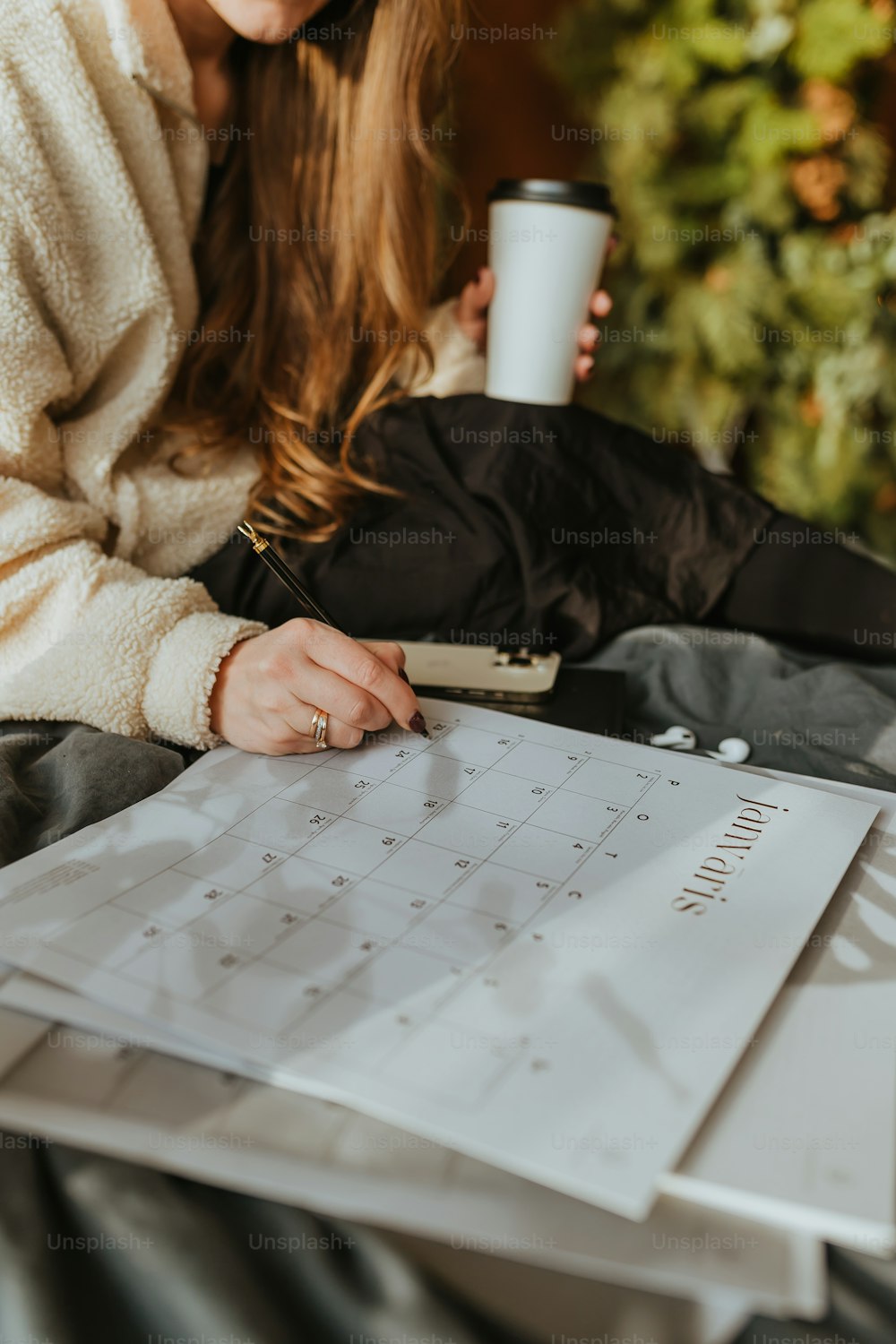 a woman sitting at a table with a cup of coffee