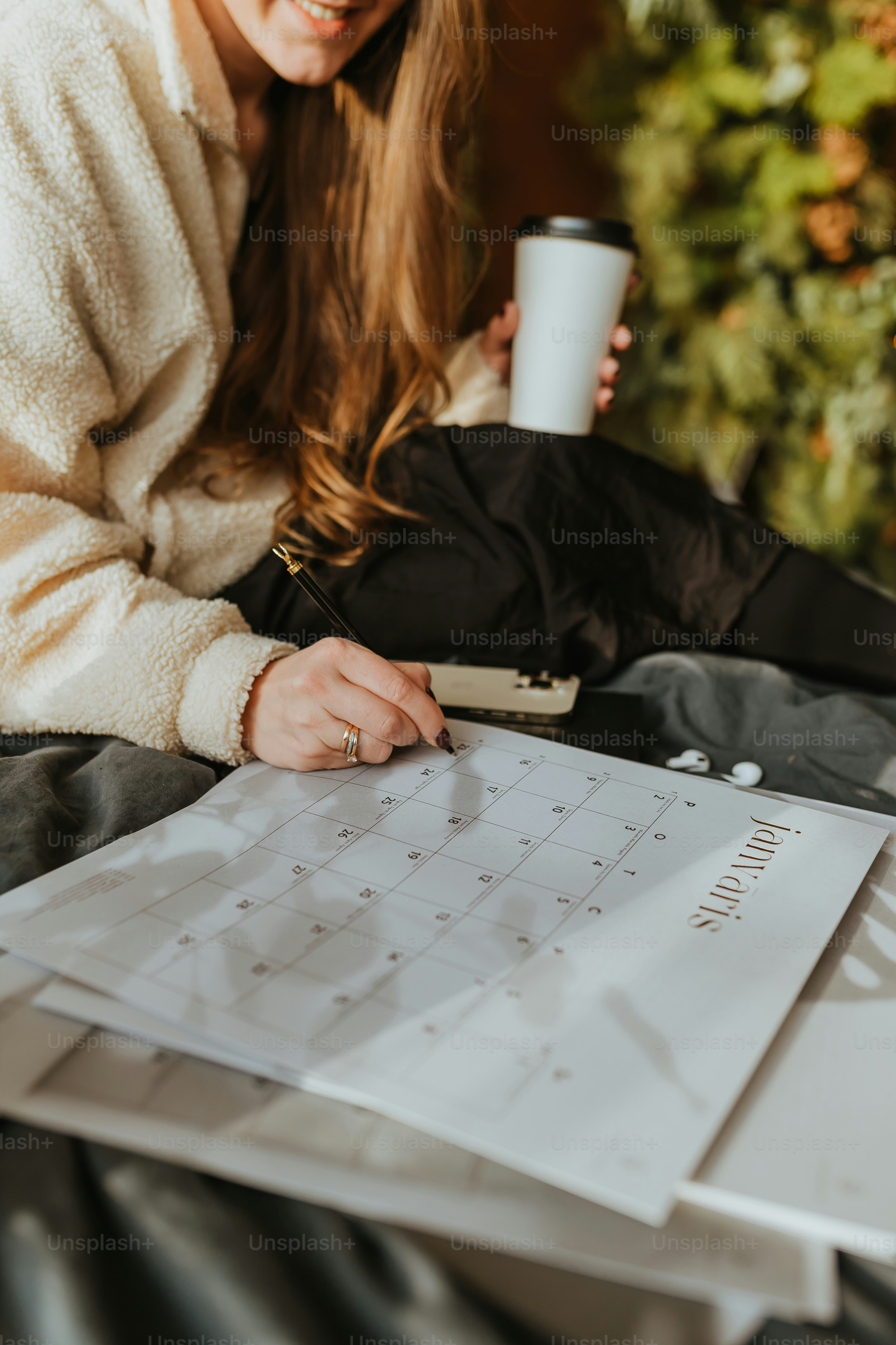 a woman sitting at a table with a cup of coffee