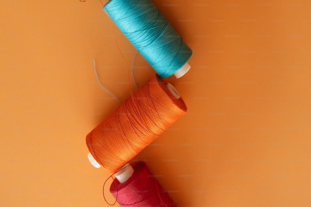 two spools of thread sitting next to each other