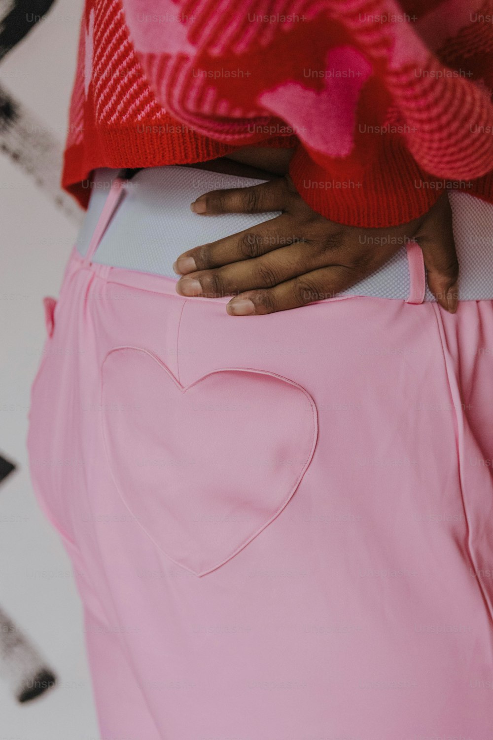 a close up of a person wearing a pink skirt
