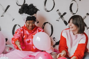 a couple of women sitting next to each other