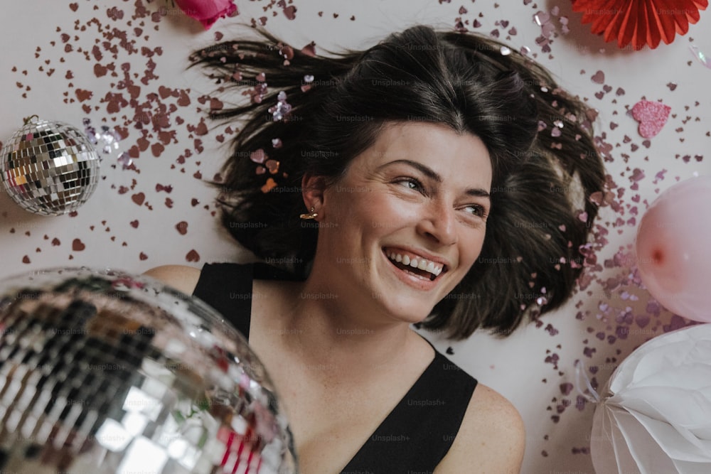 a woman laying on the floor with a disco ball in front of her