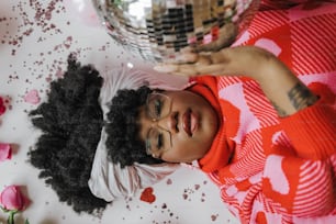 a woman in a red and white dress and a disco ball