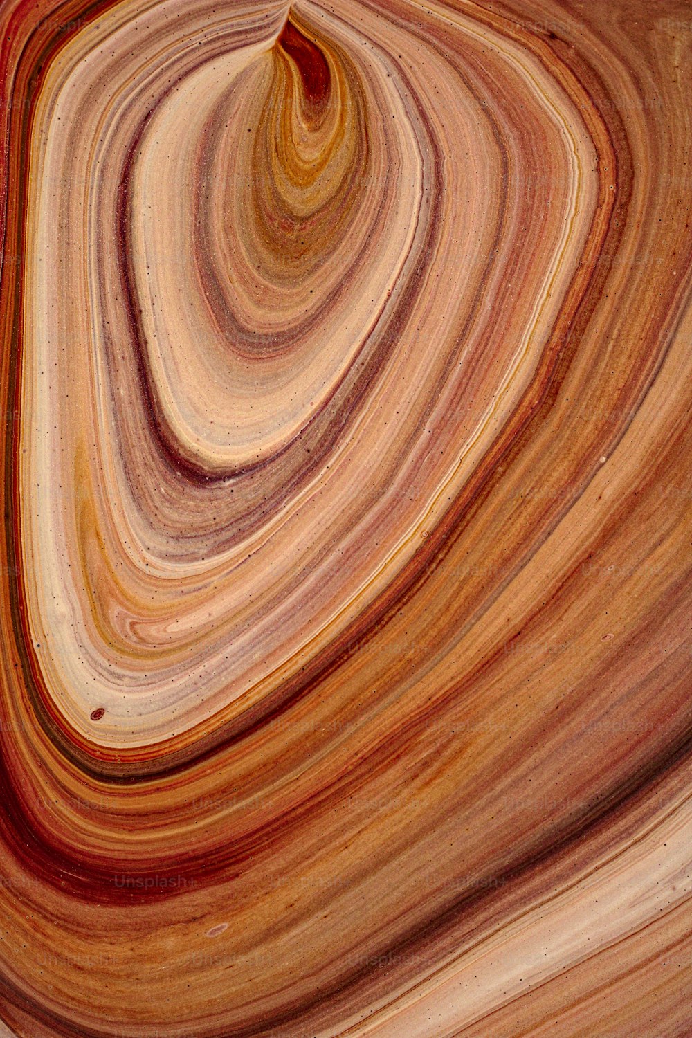 a close up view of a swirl in a marbled surface