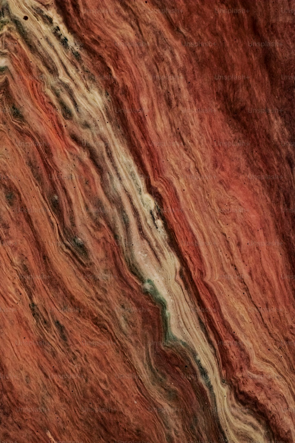 a close up of a red and brown marble