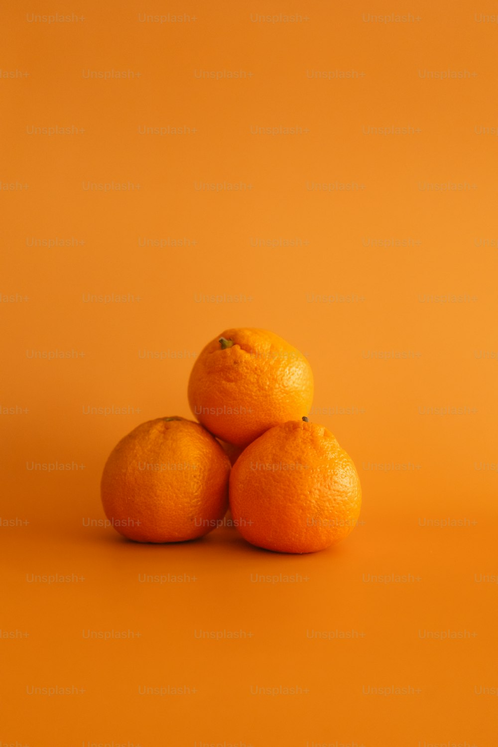 three oranges sitting on top of each other