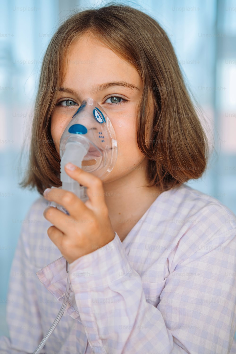 a young girl wearing a respirator mask