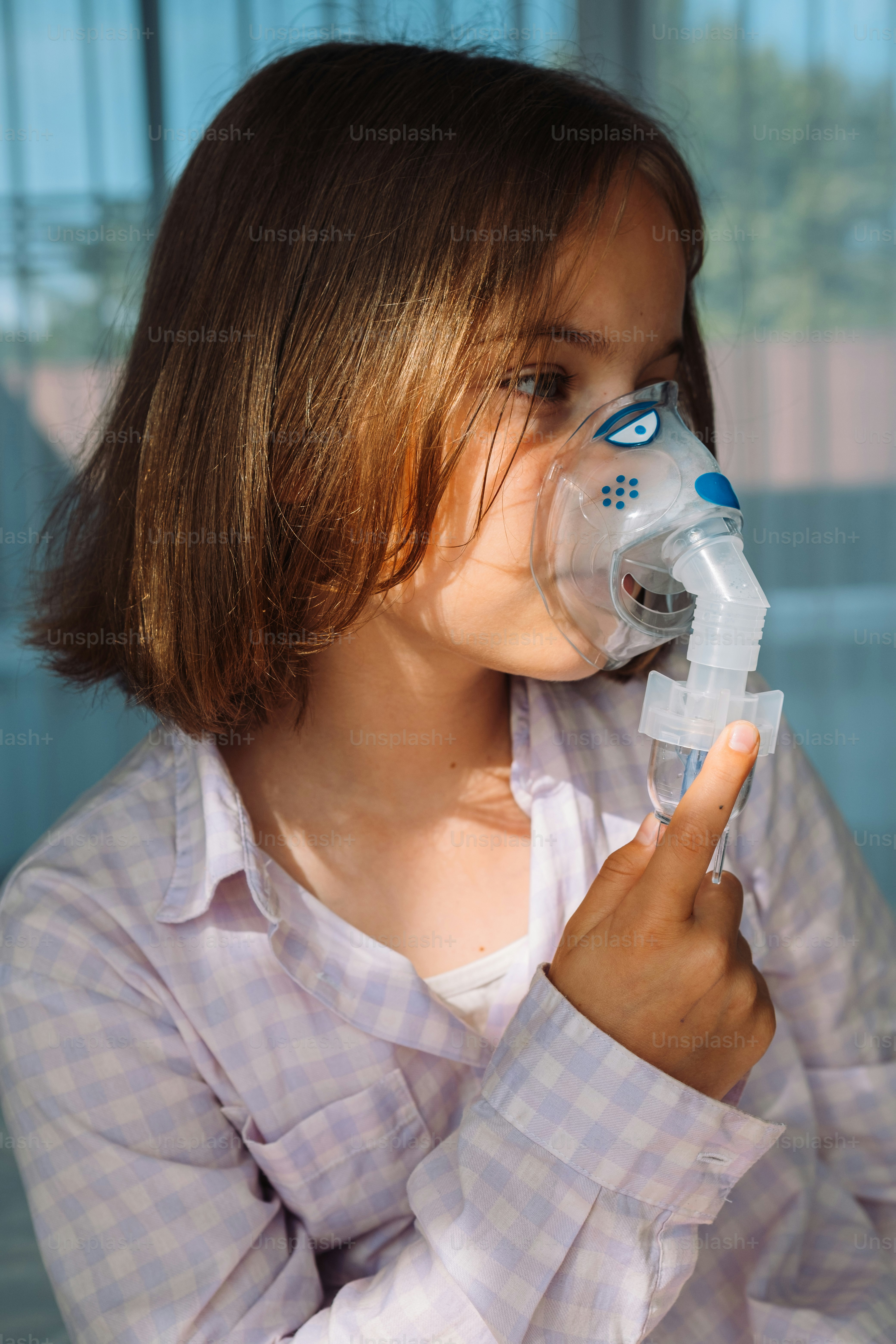 a young girl drinking from a water bottle