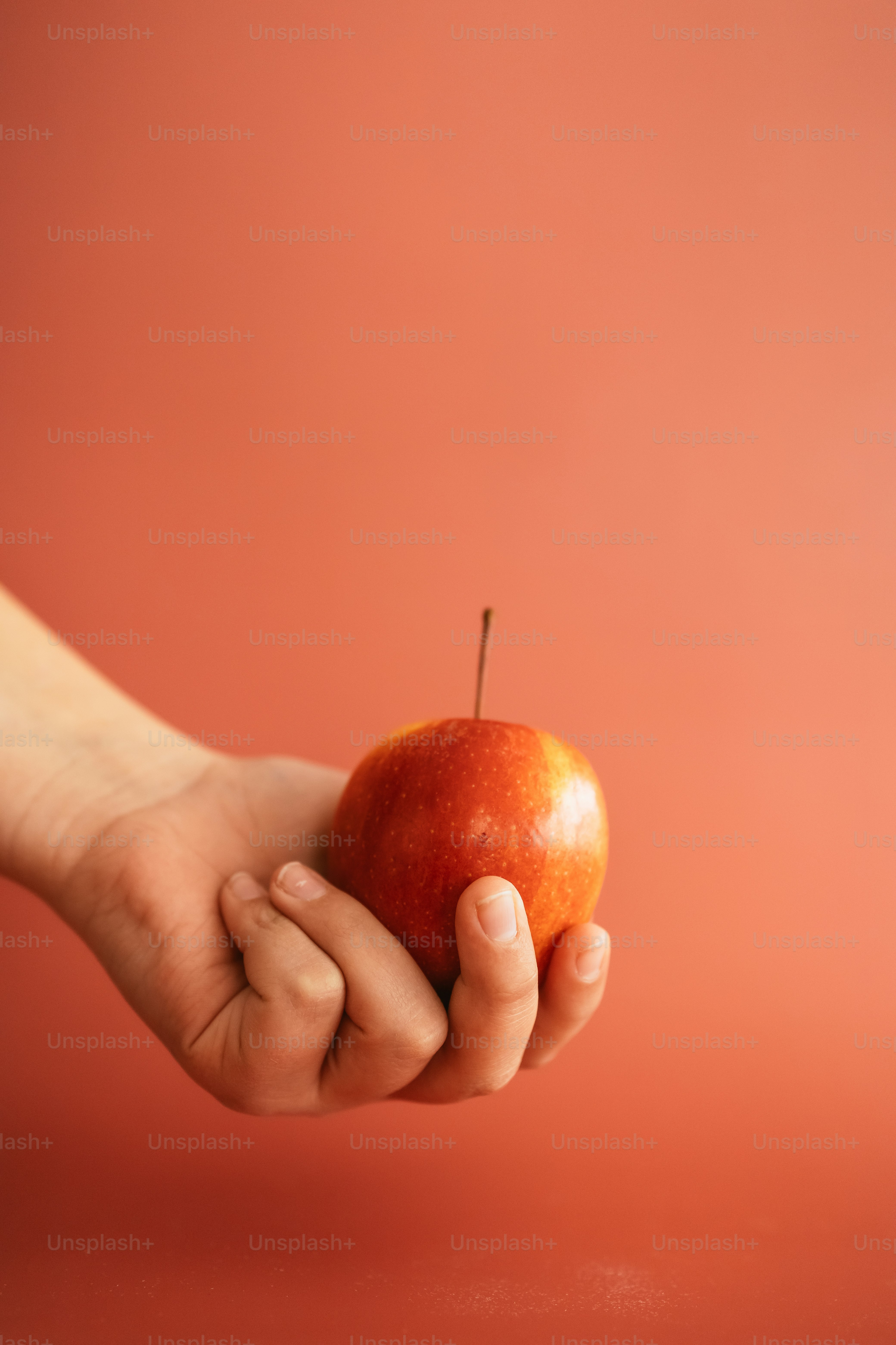 a person holding an apple in their hand