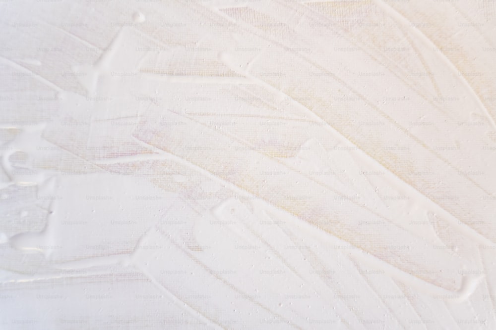 a close up of a white paint textured background