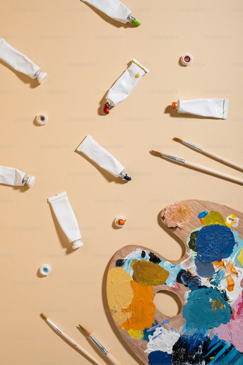 a paint palette with paintbrushes and paint on it