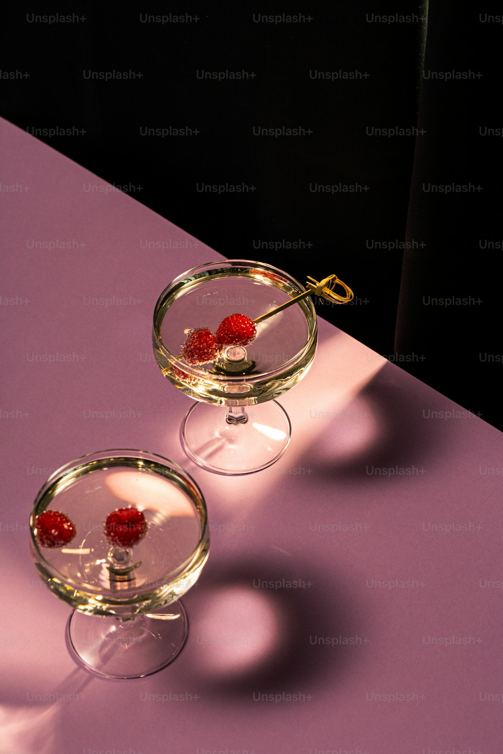 a couple of small glass bowls filled with raspberries