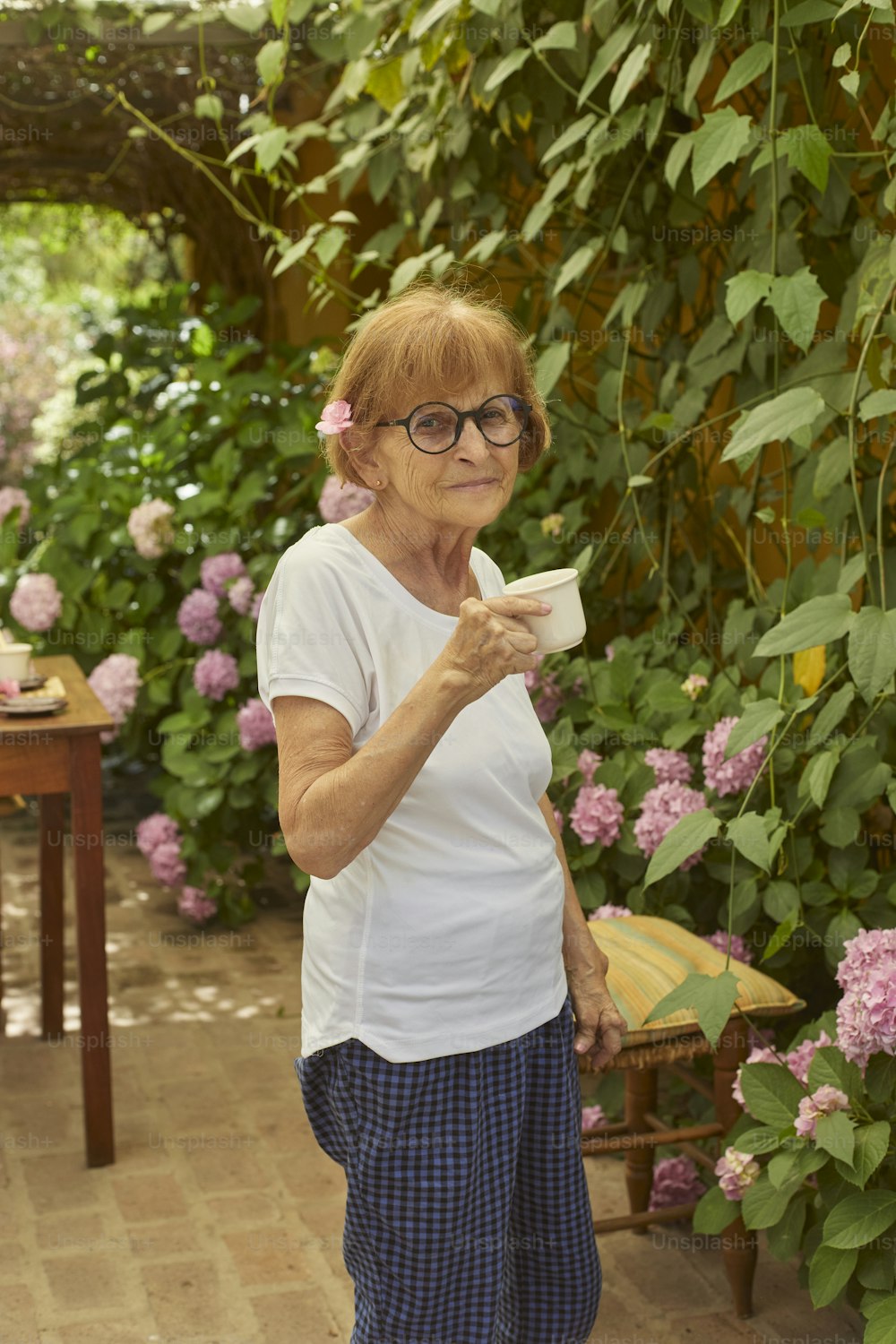 a woman in a white shirt holding a cup