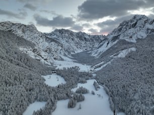 a snow covered mountain with a river running through it