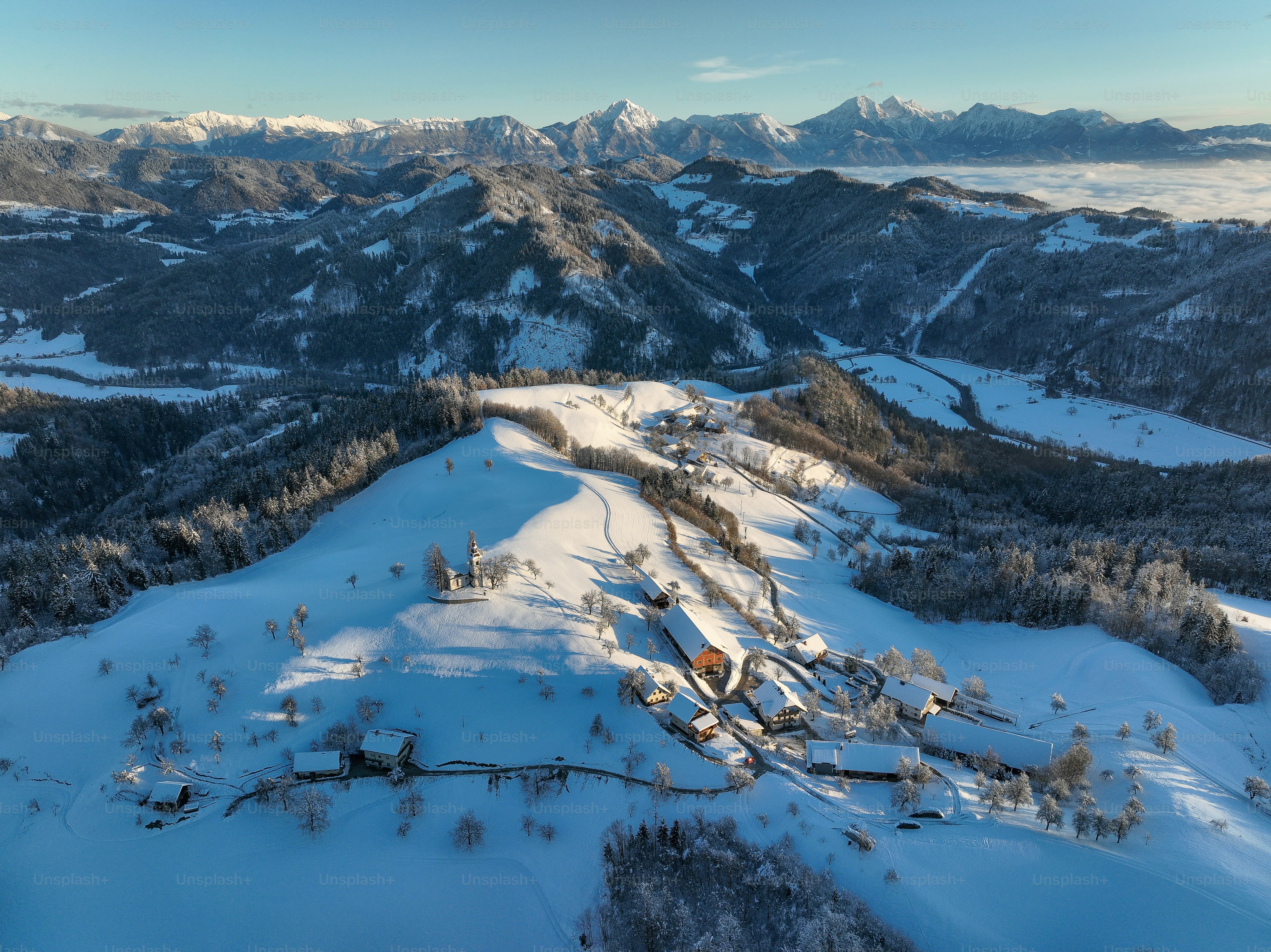 an aerial view of a snow covered mountain range