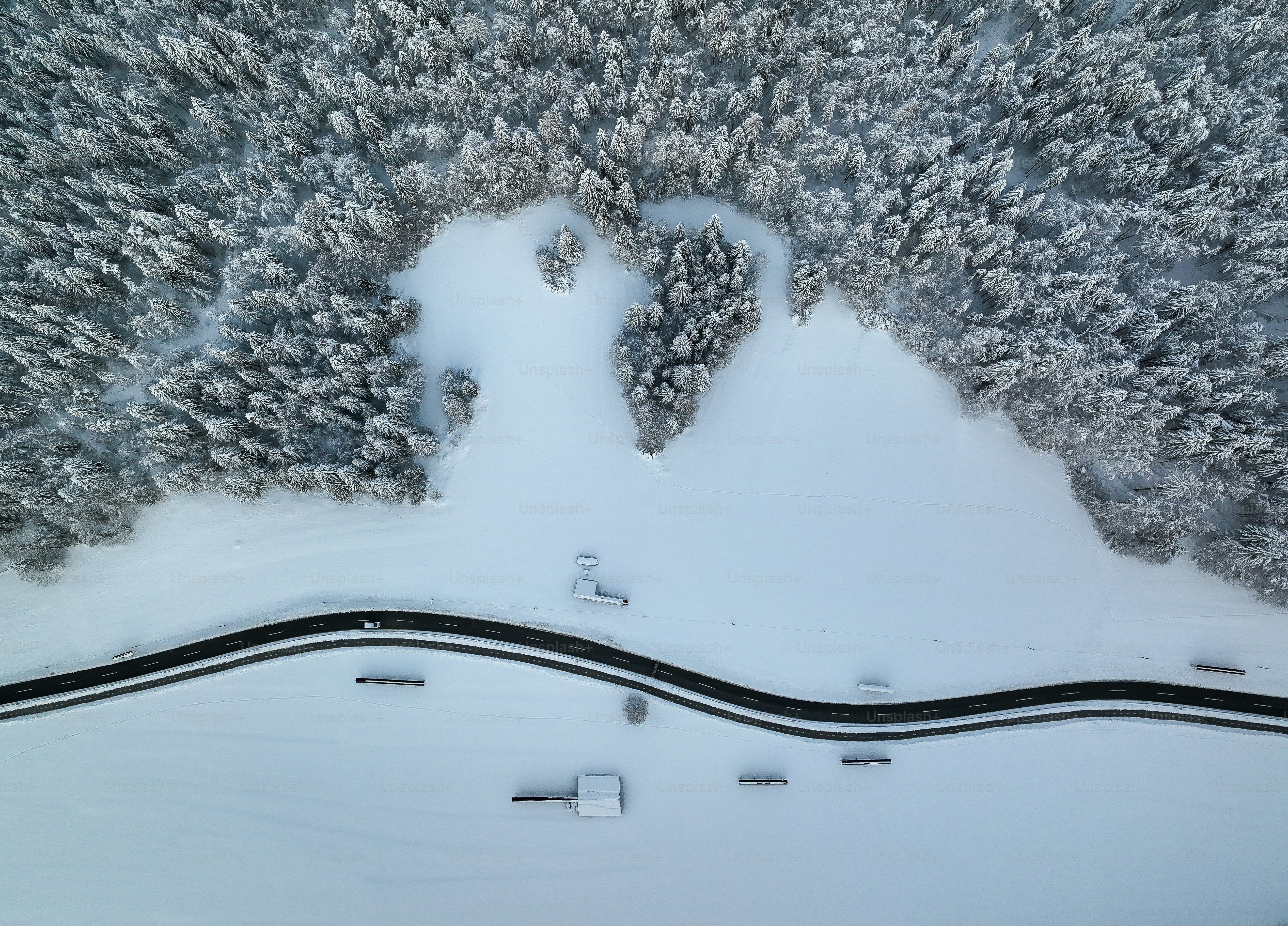 an aerial view of a snow covered road