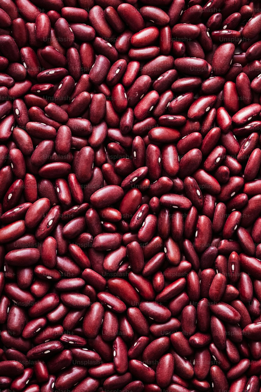 a pile of red beans sitting next to each other