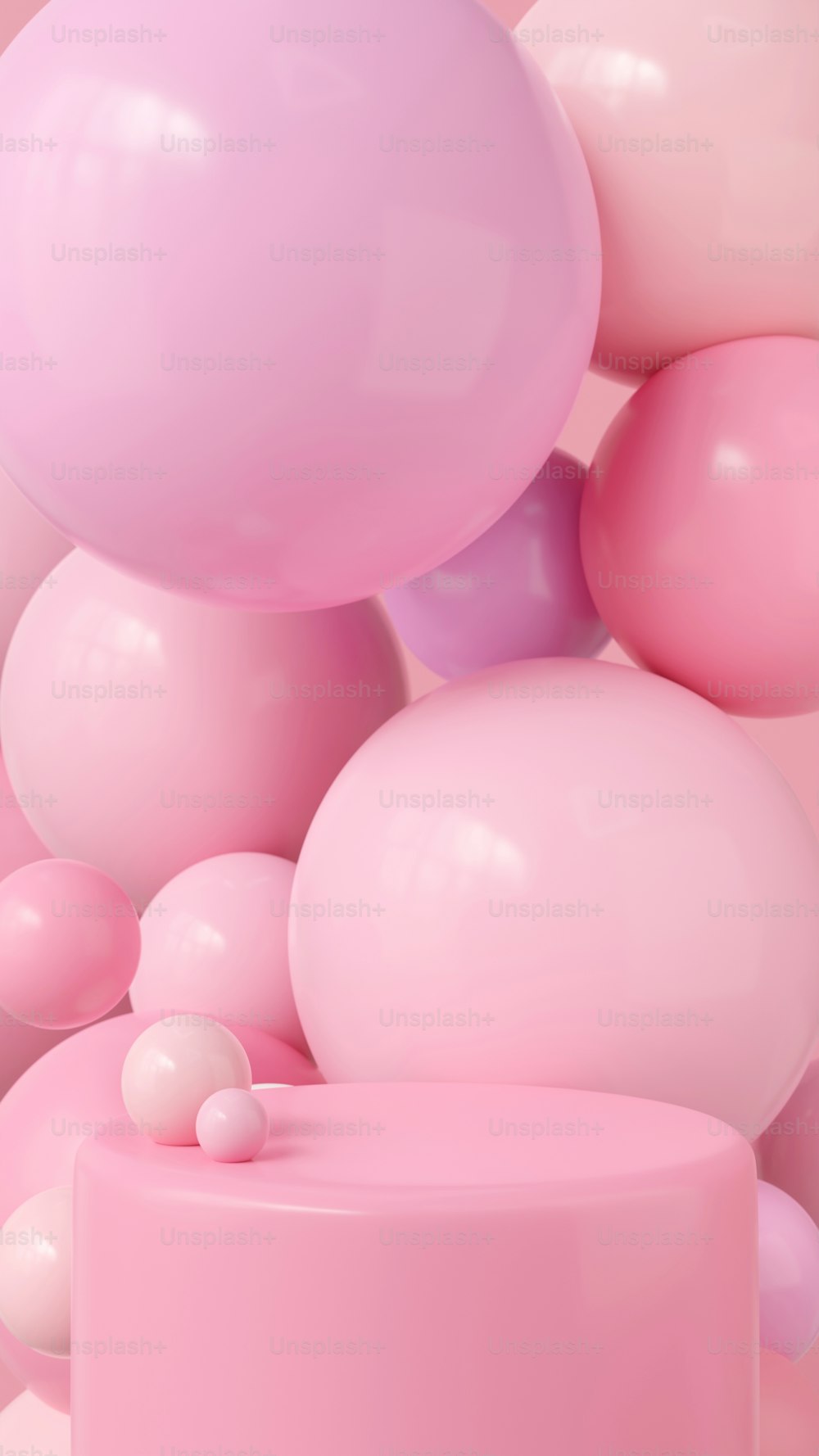 a pink cake surrounded by balloons in the air