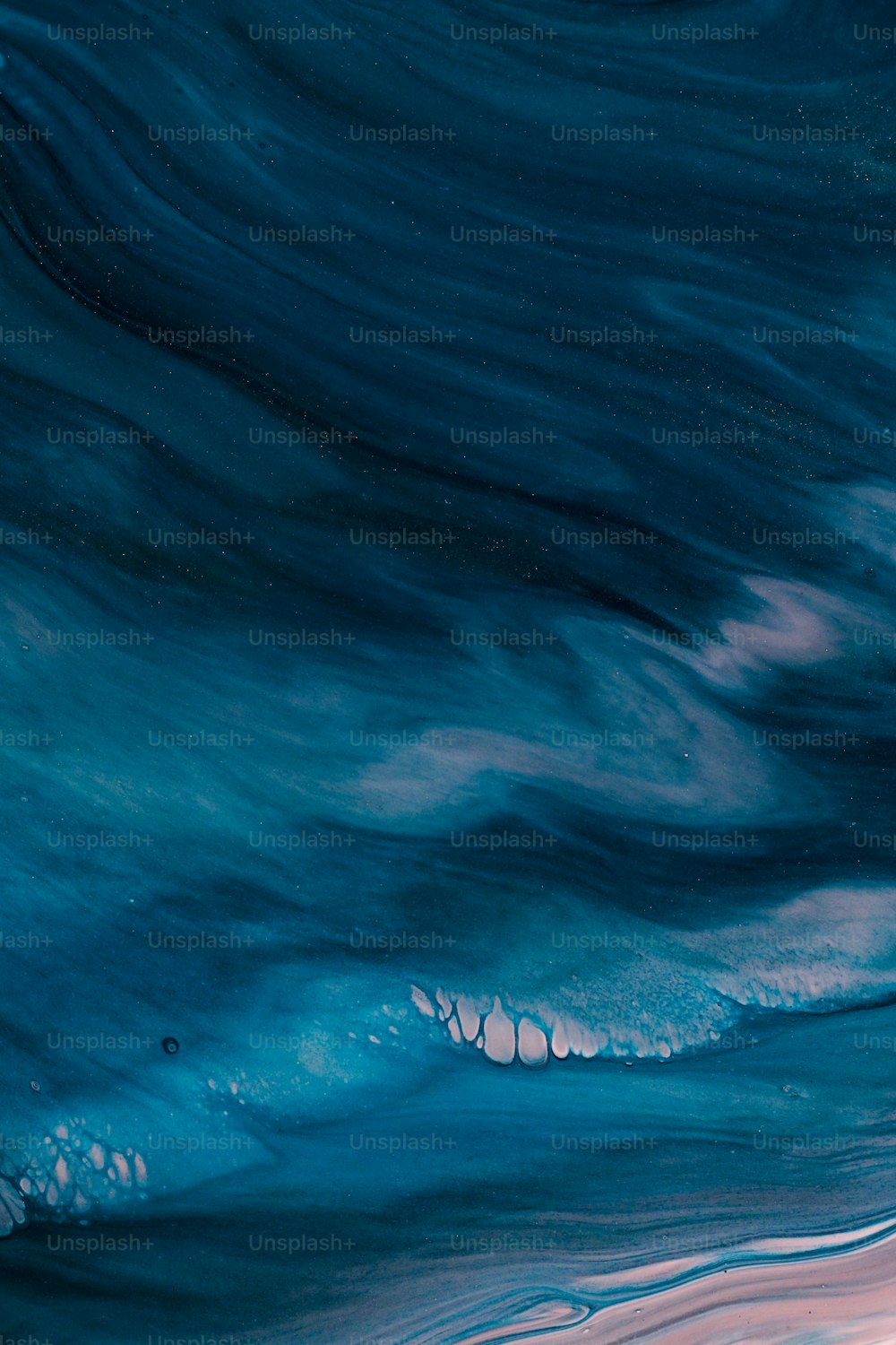 a blue and pink painting of a wave in the ocean