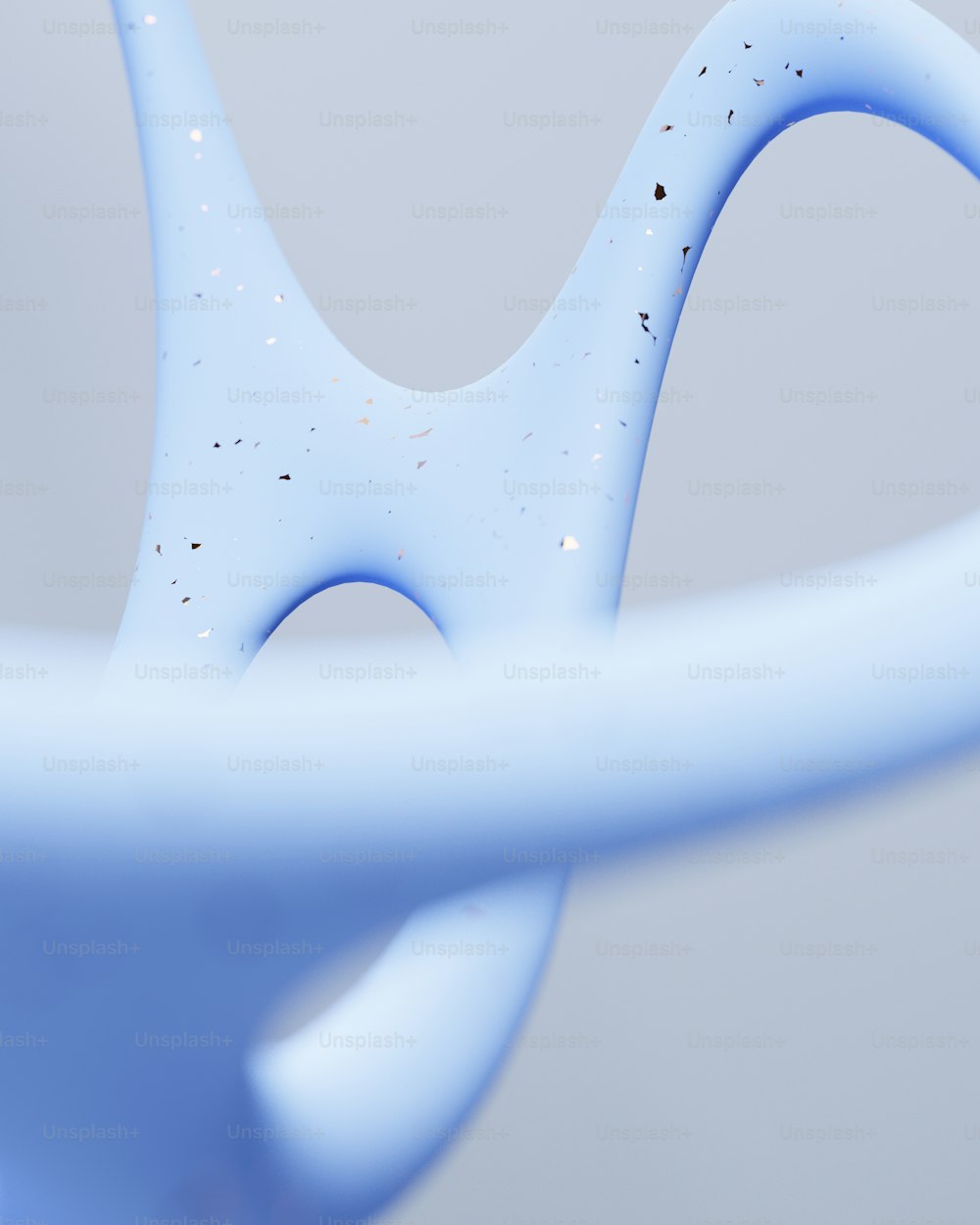 a close up of a blue object with a white background