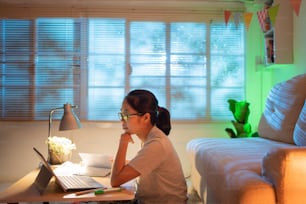 Woman sitting on a desk She is at home at night