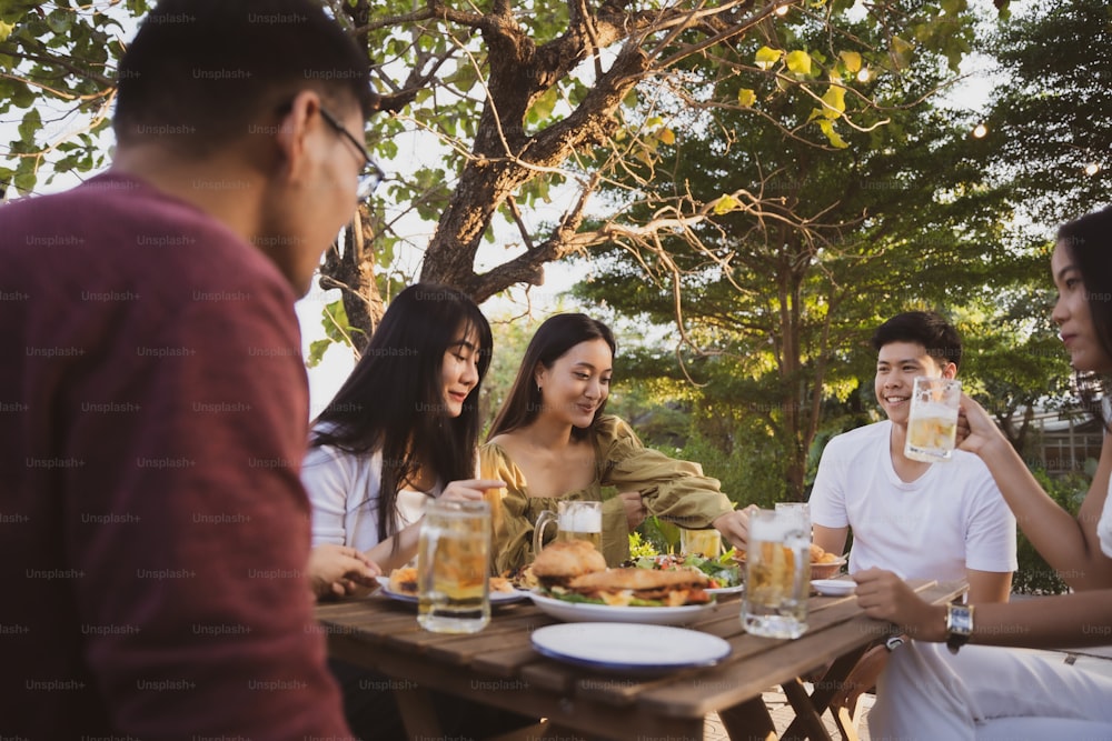 Group holiday party of asian people Eating dinner and drinking beer at home