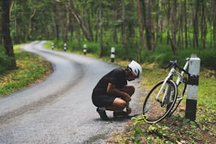 Reparación de bicicletas ciclistas en la carretera, tenía fugas de neumáticos.