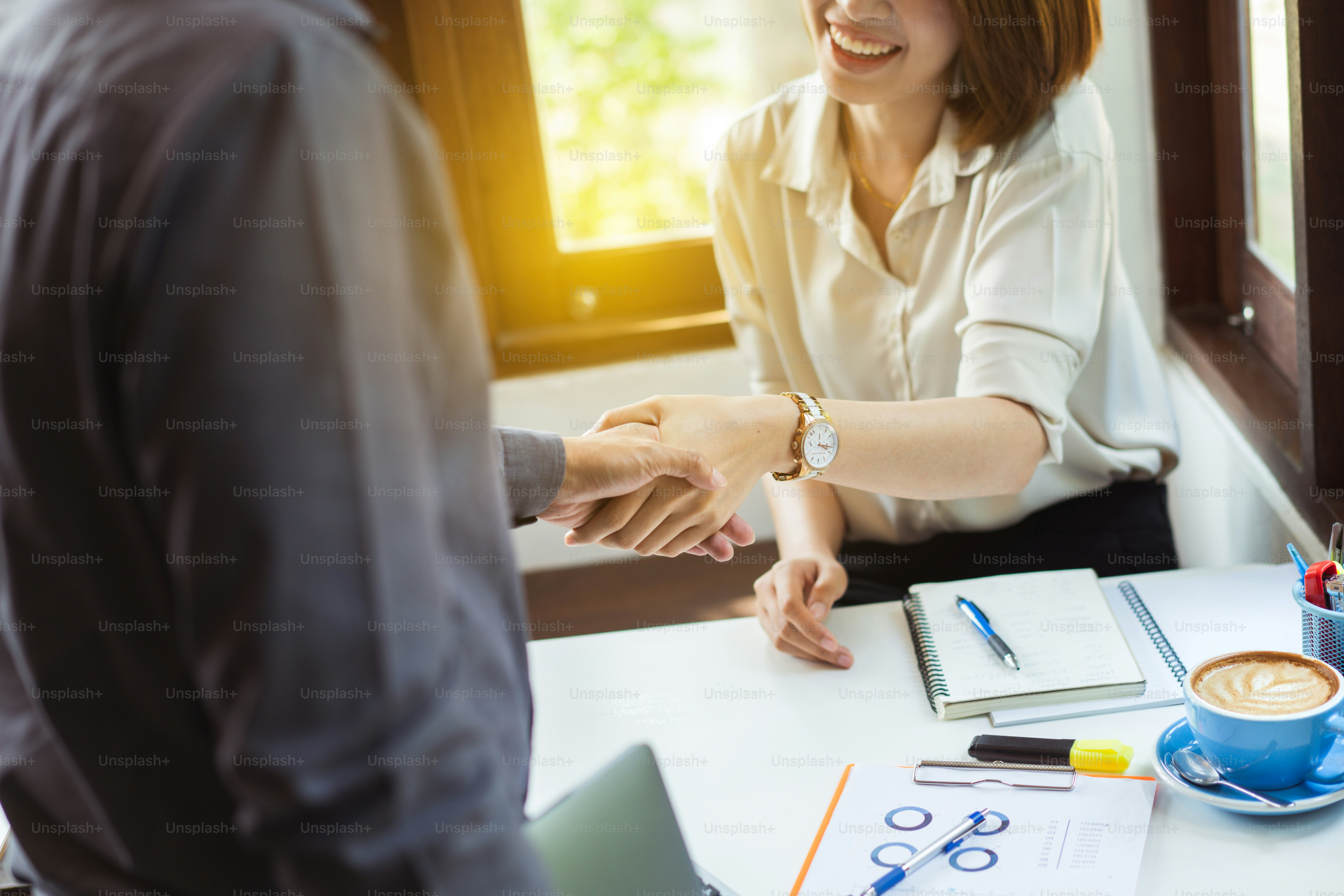 Business people shake hands They are in a coffee shop
