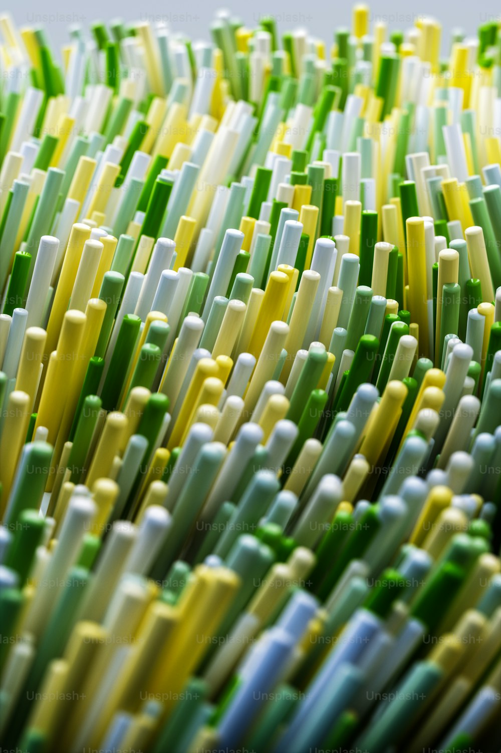 a close up of a bunch of green and yellow toothbrushes