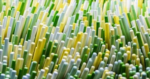 a close up of a bunch of green and yellow straws