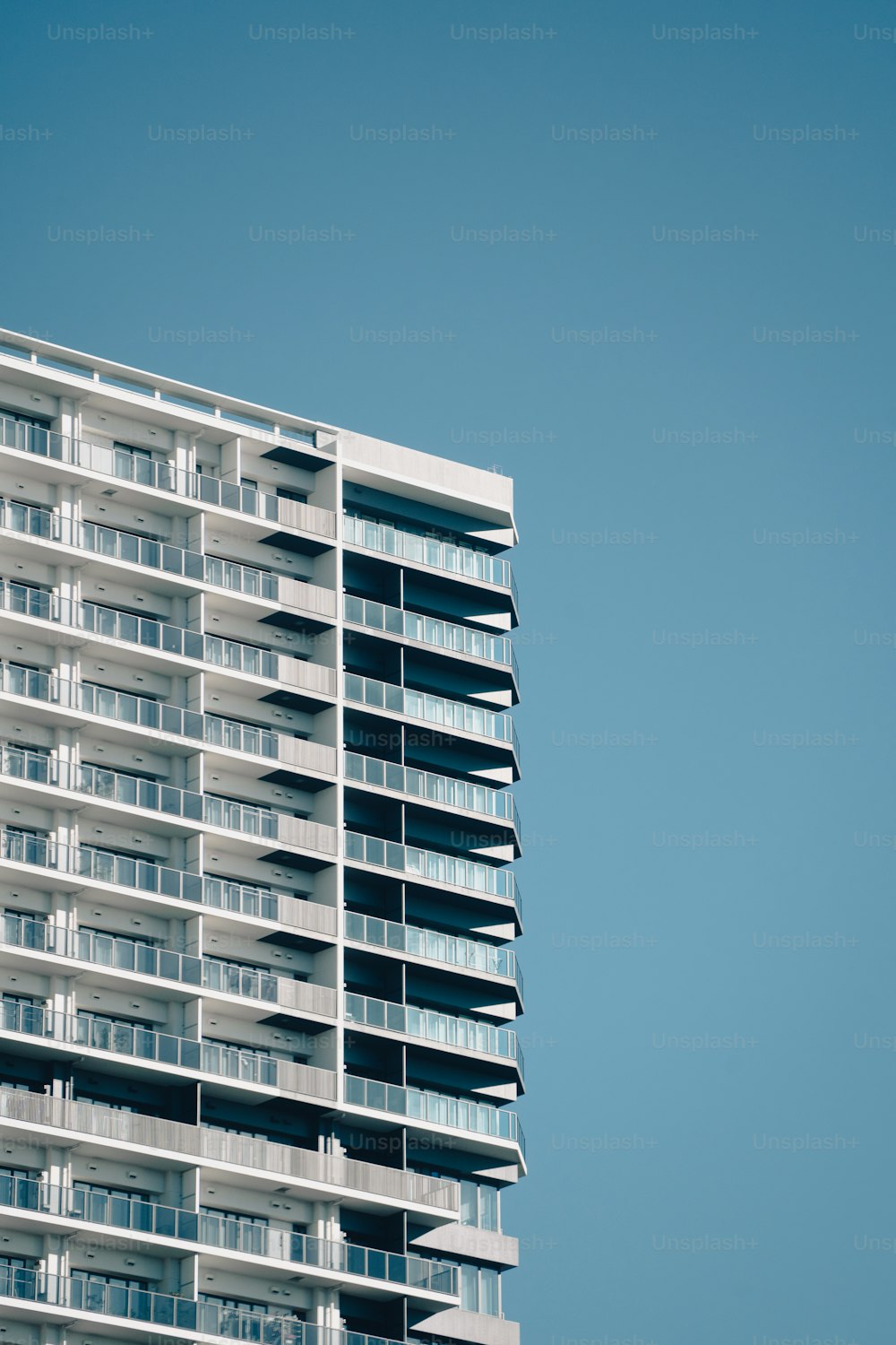 a tall building with balconies on the top of it