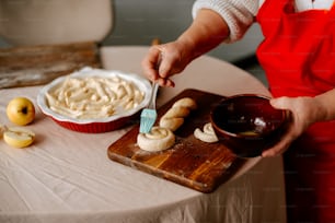 a person in an apron is cutting bananas on a cutting board