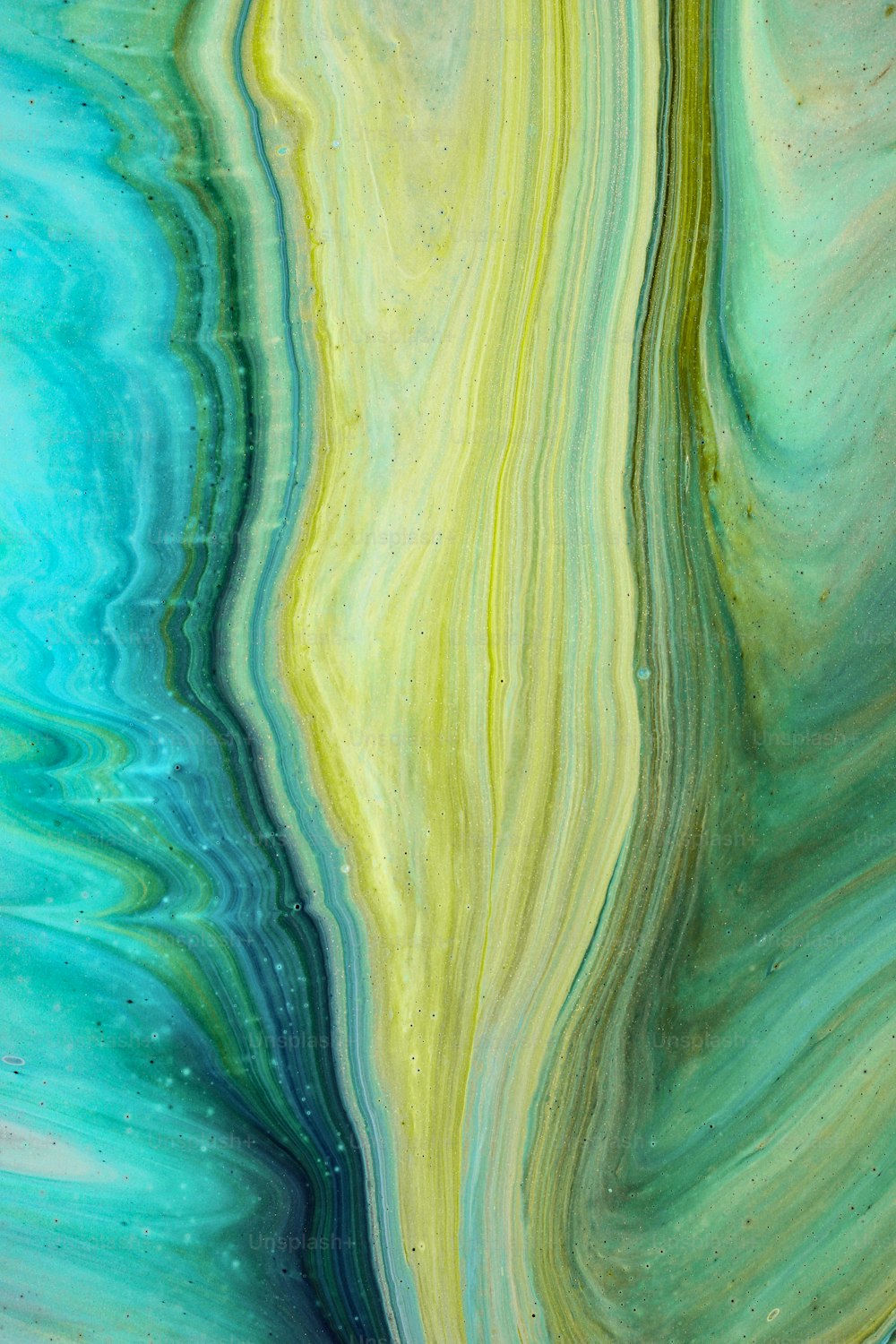 a blue and yellow fluid painting on a white background