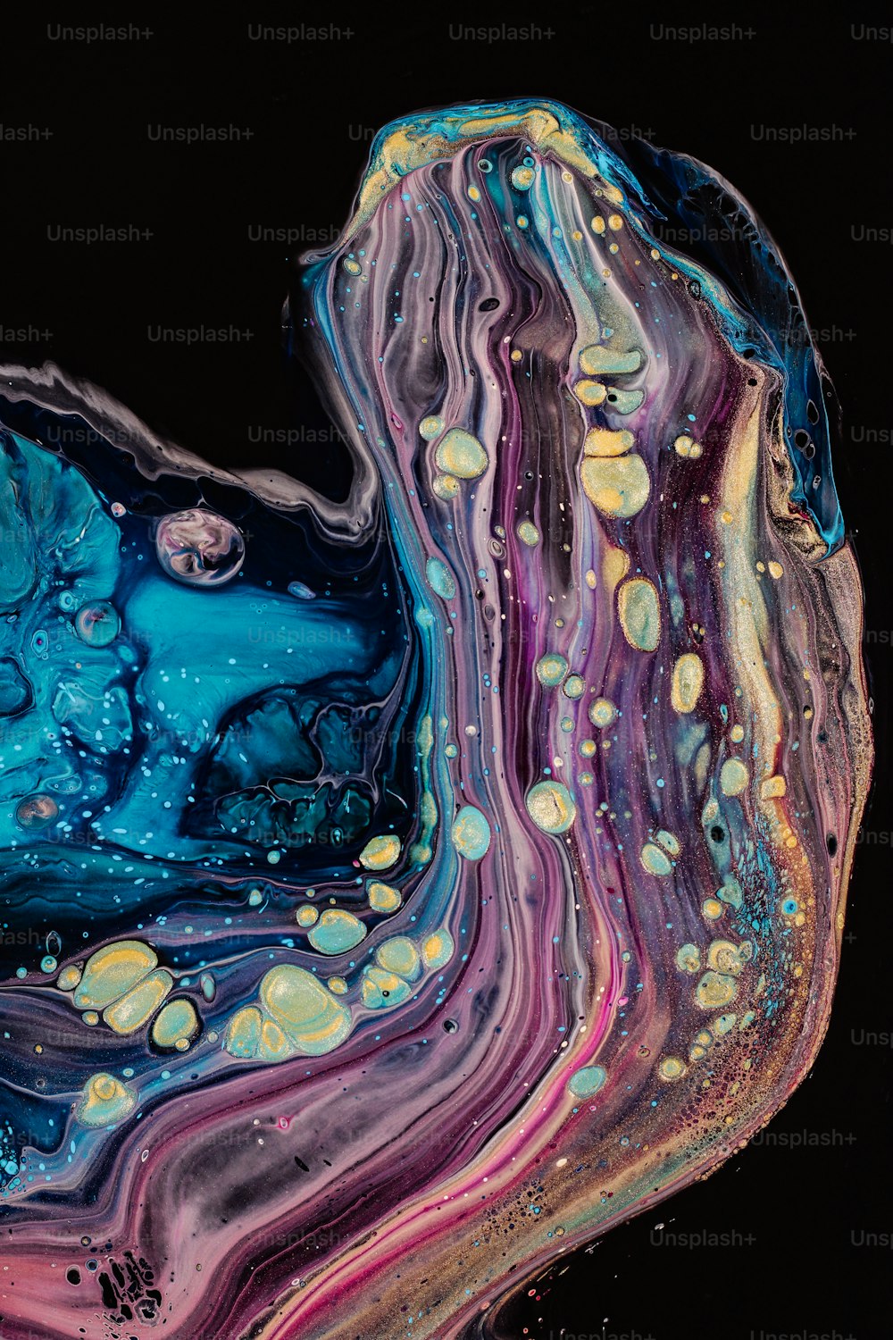 a close up of a liquid painting on a black background
