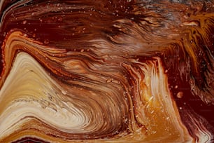 a close up of a brown and white abstract painting