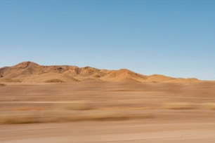 a desert landscape with mountains in the distance