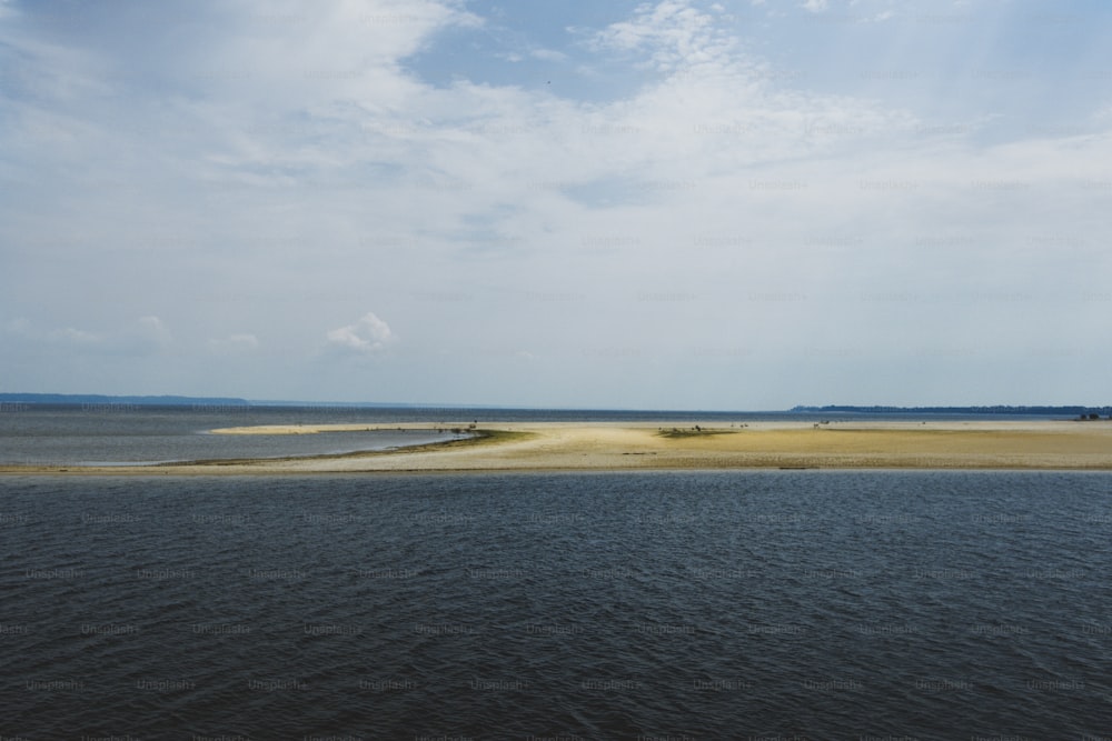 a large body of water sitting next to a sandy beach