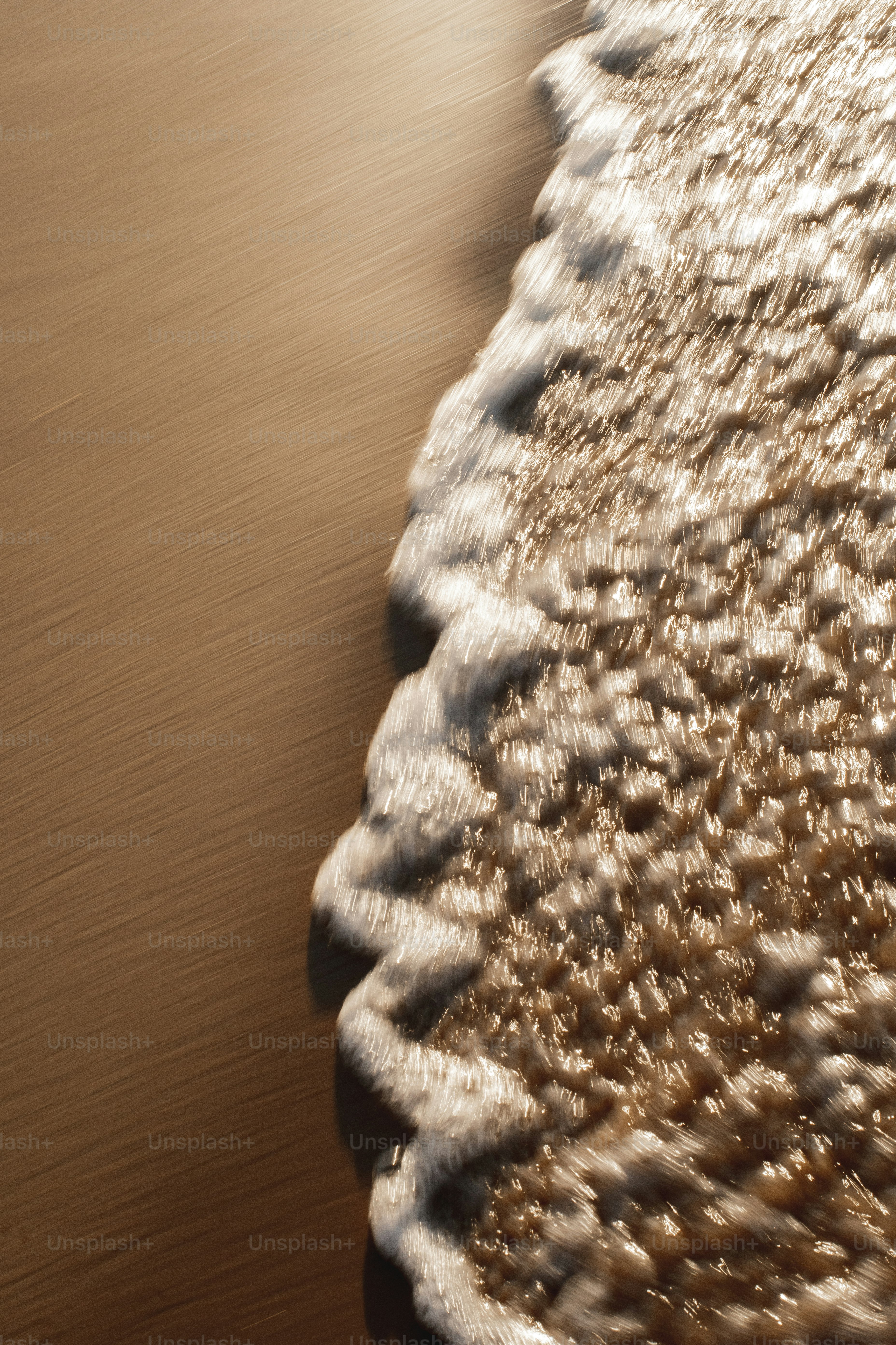 a close up of a wave on a beach