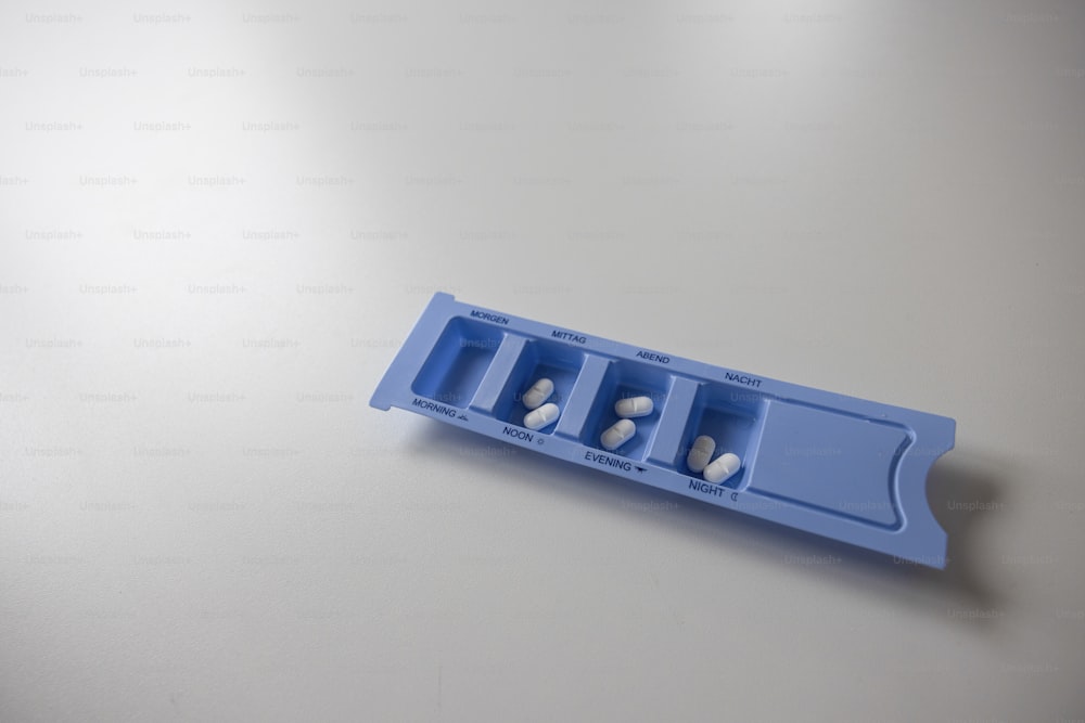a pill holder with three pills in it