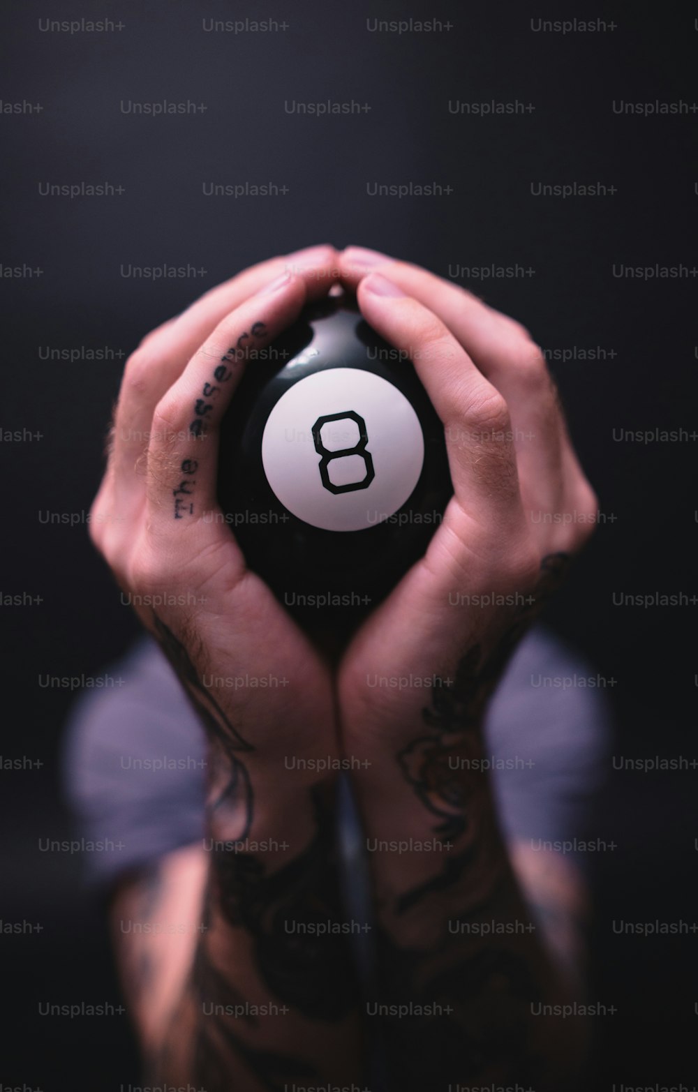 a person holding a pool ball in their hands