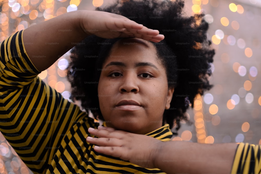 a close up of a person wearing a striped shirt