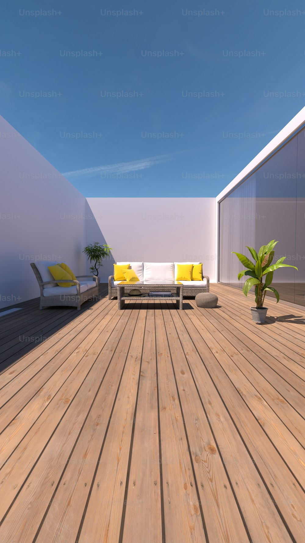 a wooden deck with a couch and a potted plant